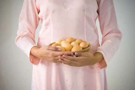 beautiful woman vietnamese holding eggsの写真素材