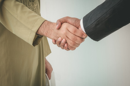 Arab businessman and businessman worker handshakingの写真素材