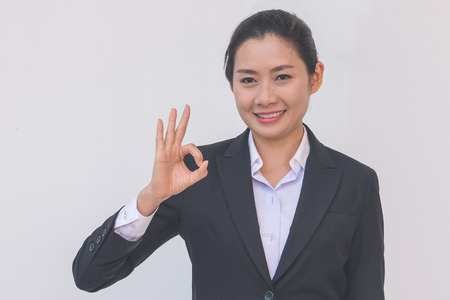businesswoman pointing up ok hand signの写真素材