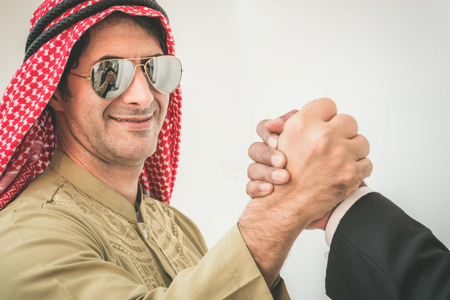 Arab businessman and businessman worker handshaking