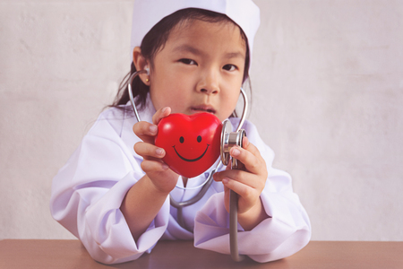 Asian girl playing as a doctor care healthy heartの写真素材