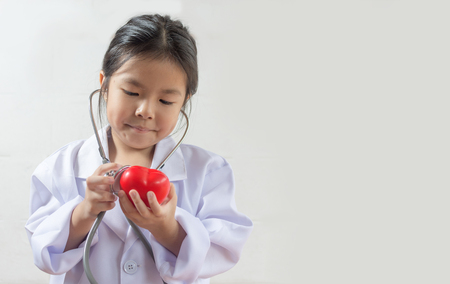 Asian girl playing as a doctor care healthy heartの写真素材