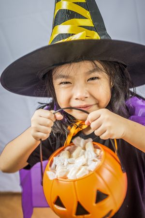 Beautiful girl witch with pumpkinの写真素材