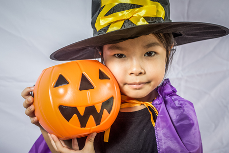 Beautiful girl witch with pumpkinの写真素材