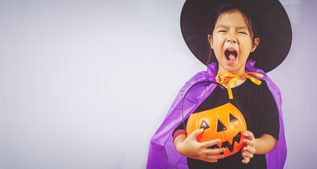 Beautiful girl witch with pumpkinの写真素材