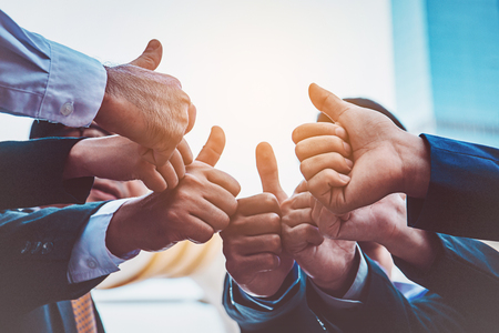 Successful business people with thumbs up and smiling, business teamの写真素材