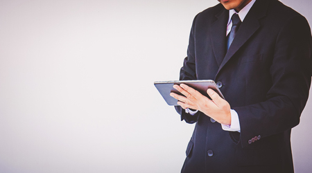 Happy businessman using digital tabletの写真素材