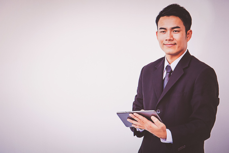 Happy businessman using digital tabletの写真素材