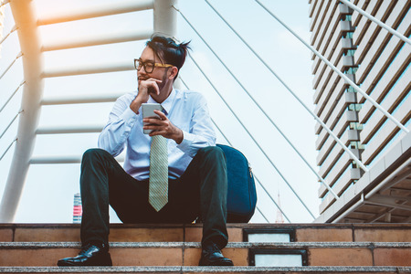 businessman in suit using smartphone at cityの写真素材