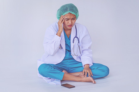 doctor headaches from working hard and stressful on white background.