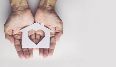 Old man hands holding small model family , concept familyの写真素材