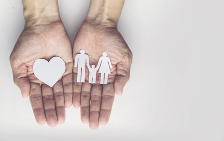 Old man hands holding small model family , concept familyの写真素材