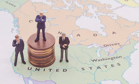 Miniature people, businessman standing on map Americanの写真素材