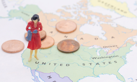 Miniature people, businesswoman standing on map Americanの写真素材