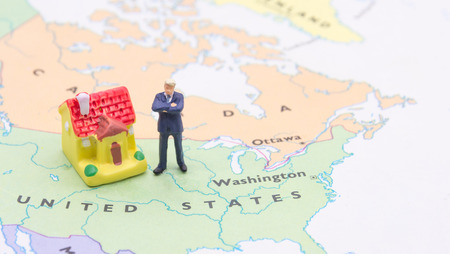 Businessman and house on map American. Miniature people