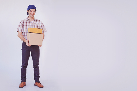 Asian young man holding box package, delivery man