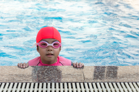 young girl swimming in pool.の写真素材