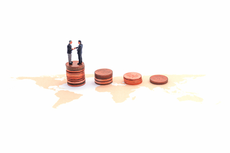 Miniature businessman Handshake on world map. on white blackground