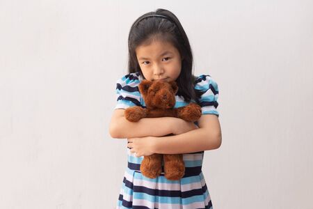 asia girl hugging a teddy bearの写真素材