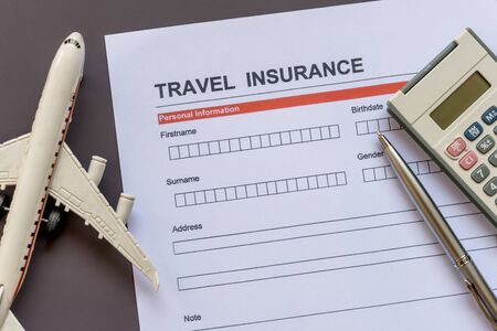 Travel  insurance form with model and policy documentの写真素材