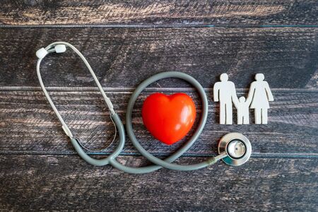 Red heart, stethoscope and icon family on wooden desk. Medical Insurance Conceptの写真素材