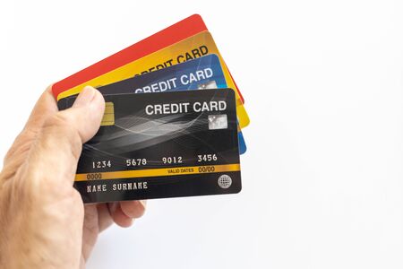 Hand holding credit card isolated on whiteの写真素材