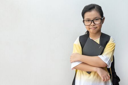 Asian girl elementary school with book and bag. Back to school. education conceptの写真素材