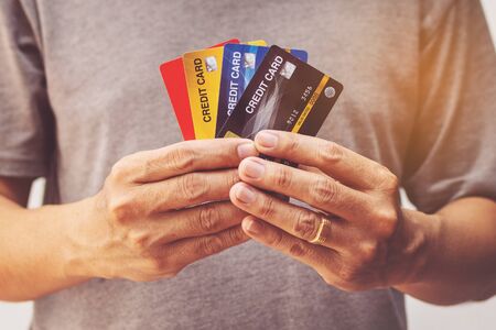 man showing bunch of credit cardsの写真素材