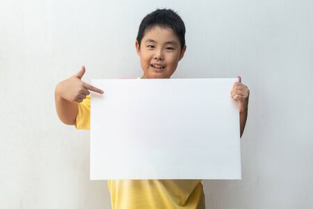 Asian boy holding empty Whiteboard. Concept of educationの写真素材