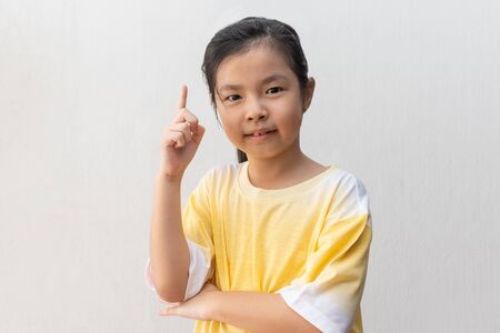 Young and cute Asian little girl thinkingの写真素材