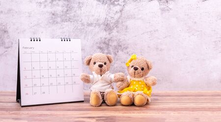couple teddy bear with calendar on table wooden. Valentine's Day celebrationの写真素材