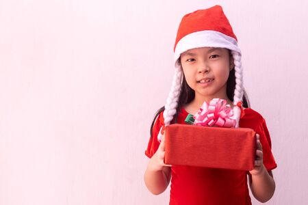 Asian girl in Elf clothes holding gift. Merry christmasの写真素材