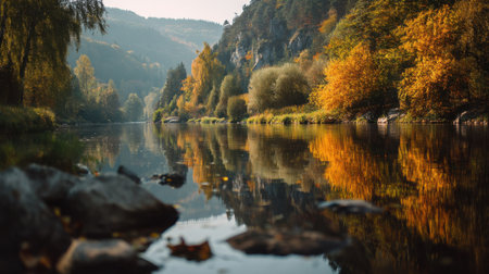 An autumn river forest reflection calm water mountain valley colorful foliage tranquil landscape nature scenery fall season scenic view peaceful outdoorの素材
