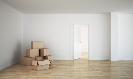3d rendering of an empty room with cardboard boxes and an open doorの写真素材
