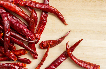 Background of dried chillies on wooden table
