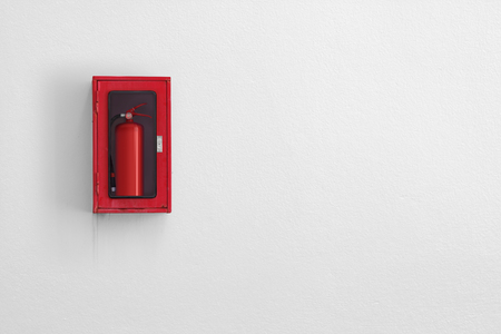 Fire Extinguisher in red cabinet on white wall background.