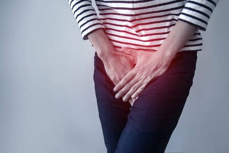 Woman with hands holding her crotch from bladder or uti pain.Symptom of cystitis-Healthcare and medical concept.の写真素材