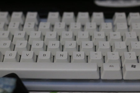 Keyboard of a computer with white keys. Close-up.
