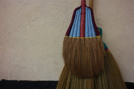 Close up of a broomstick with long hair in front of a white wallの写真素材