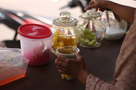 Thai people drink water from plastic bottle at street food market.の写真素材
