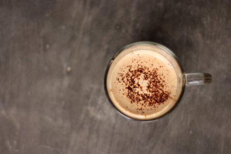 Cappuccino coffee in a glass cup on the table.の写真素材