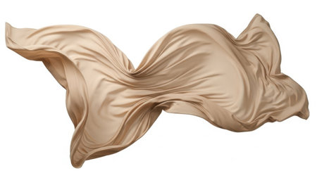 A close-up view of a flowing beige silk fabric, elegantly draped and cascading in a graceful manner.の素材