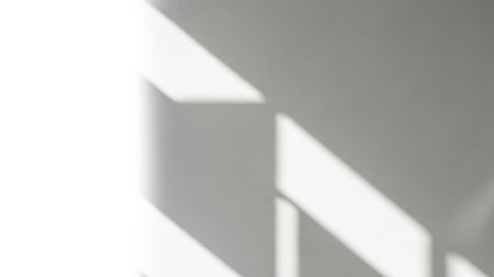 A simple and clean image showcasing the interplay of shadows and light on a white wall.の素材