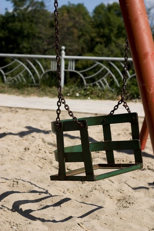 broken swing on playground with sandのeditorial素材
