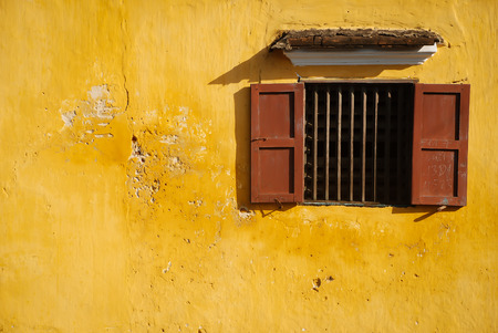 opened-window on yellow wallの写真素材