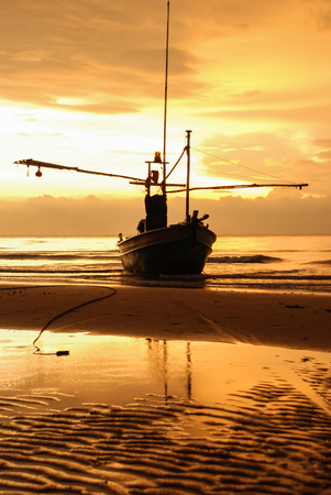 Boat on the beach at sunrise timeの写真素材