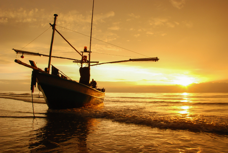 Boat on the beach at sunrise timeの写真素材
