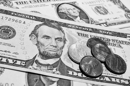 Dollar bills with coinsの写真素材