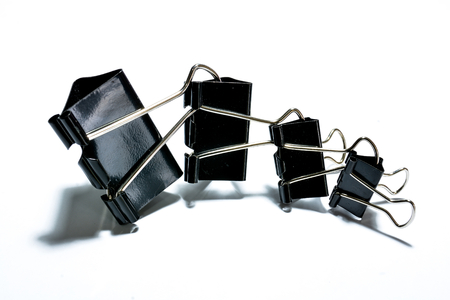 Black paper clips isolated on white backgroundの写真素材