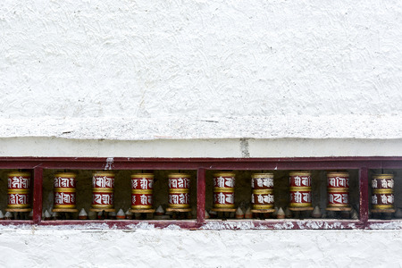 Prayer wheels on white wallの写真素材